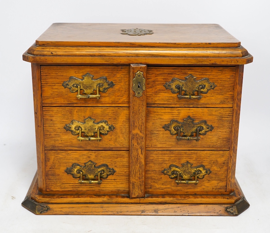 An early 20th century oak collector's cabinet, retailer Fisher, 188 Strand, 38cm wide. Condition - fair